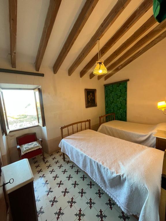 a bedroom with two beds and a window at La Torre Blai in Jijona