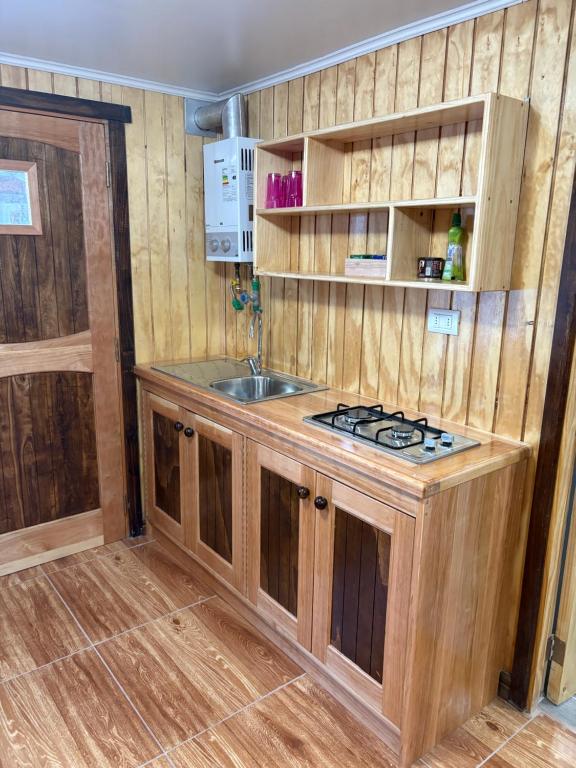 a kitchen with a sink and a stove at ruta de los parques in Chile Chico