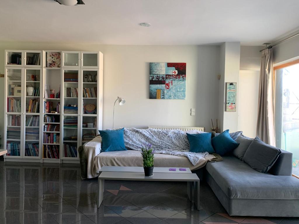 a living room with a couch and a table at Eden Garden near Knossos in Skalánion