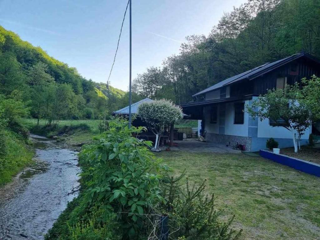 a house with a river in front of it at Dolina Mira in Srebrenik