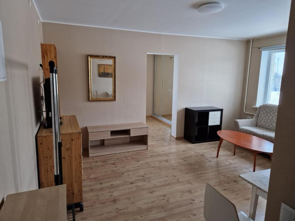 a living room with a couch and a table at Quiet and comfortable apartment in Rakvere