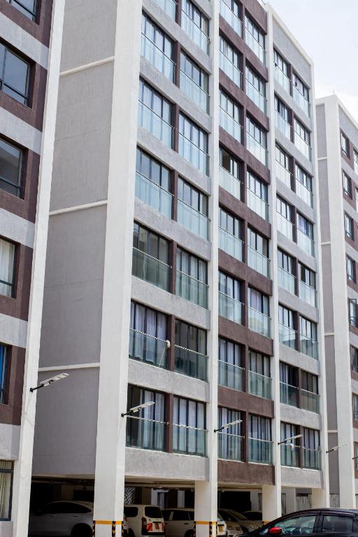 a tall building with many windows in a city at Studio near JKIA and SGR Syokimau in Nairobi