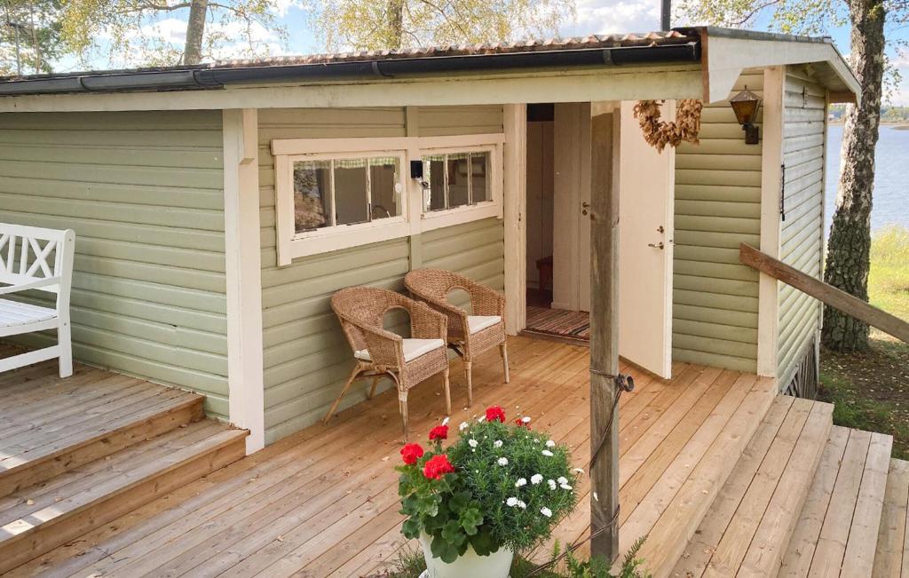 a small shed with a table and chairs on a deck at Beautiful Home In Tranås With Lake View in Tranås