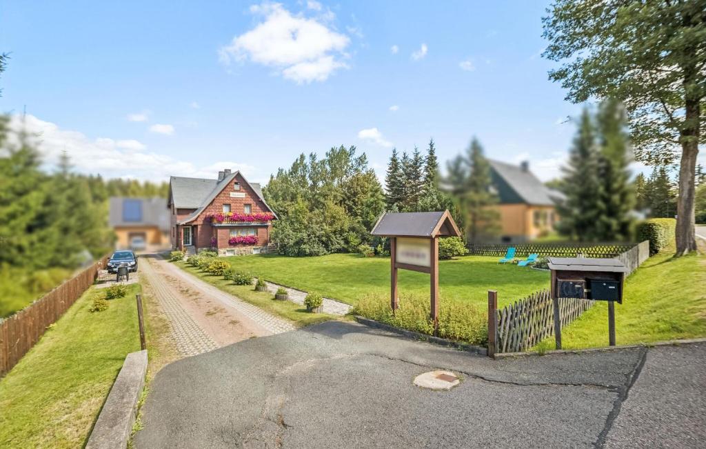 a house with a fence and a road at Ferienwohnung Neuhermsdorf in Neuhermsdorf