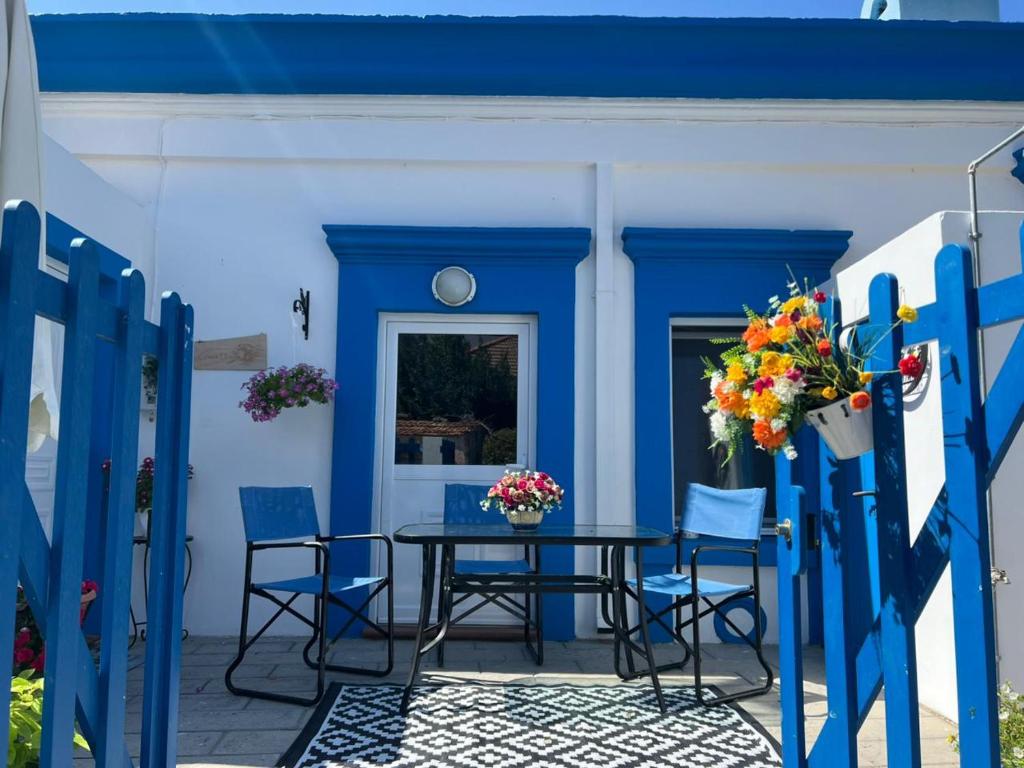 a blue house with a table and chairs at My sweet Greek dream - Traditional home in Soroni