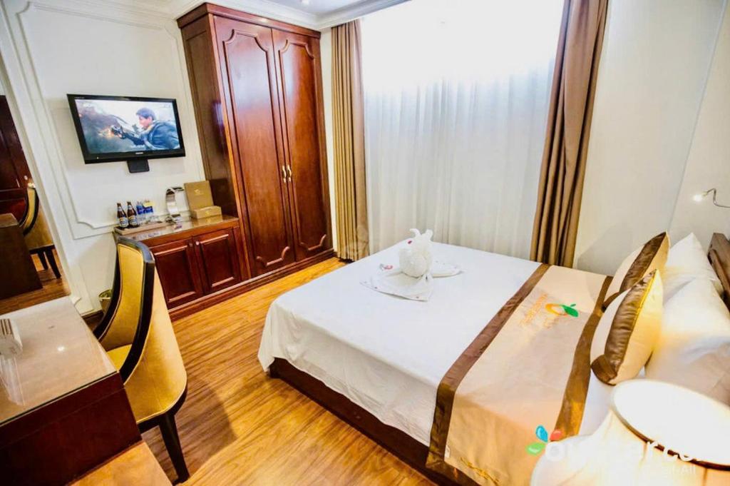 Ένα ή περισσότερα κρεβάτια σε δωμάτιο στο ORANGE Hotel & Suites - Danang City CENTER, near Dragon Bridge