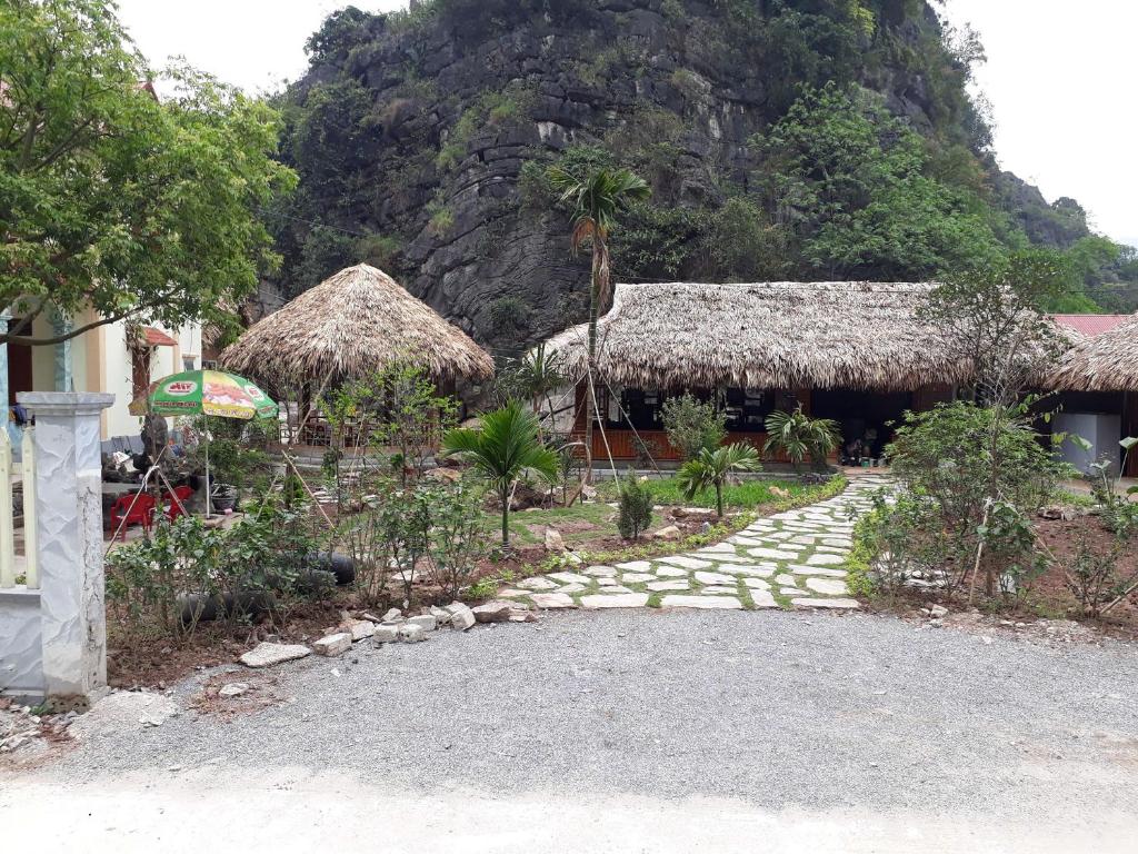 a walkway leading to a building with a mountain at Trang An Maison Retreat in Nguyên Ngoại