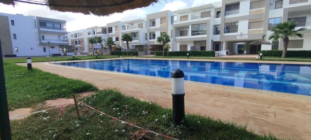 a swimming pool in front of a building at Malaga Beach in Mansouria