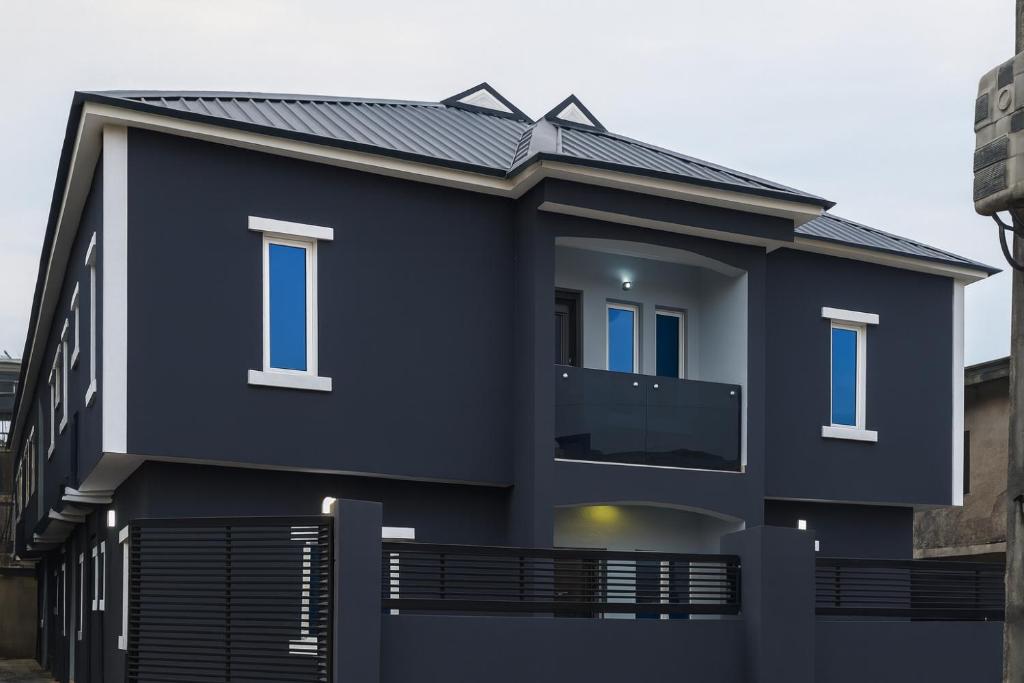 a black house with a metal roof at TJ Apartments in Ikeja
