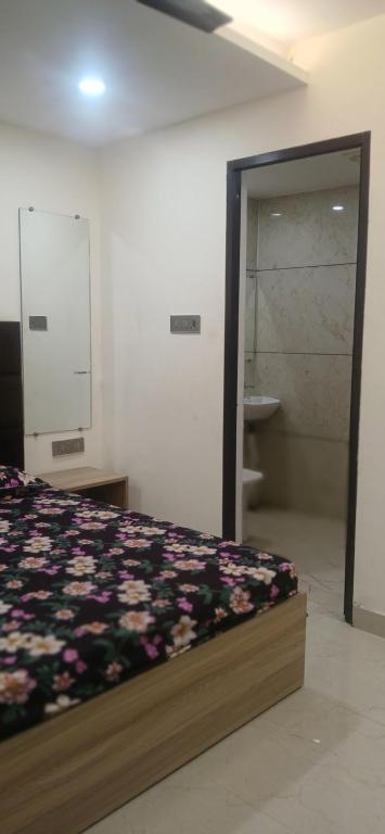 a bedroom with a bed and a sliding glass door at Arora golden guest house in Amritsar