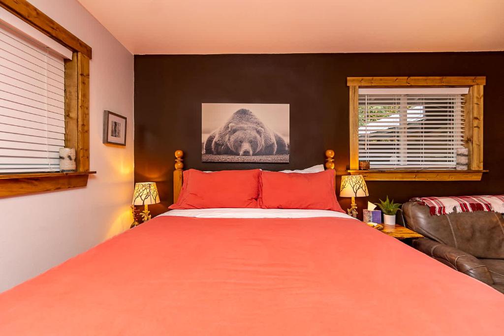a bedroom with a large bed with red pillows at Mt Pilchuck River Cabin in Granite Falls
