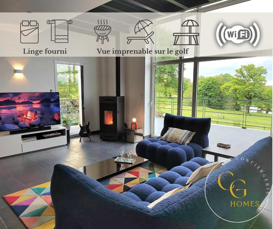 a living room with two blue couches and a tv at Villa Albatros, Vue golf imprenable, WIFI, Confort in Nesmy