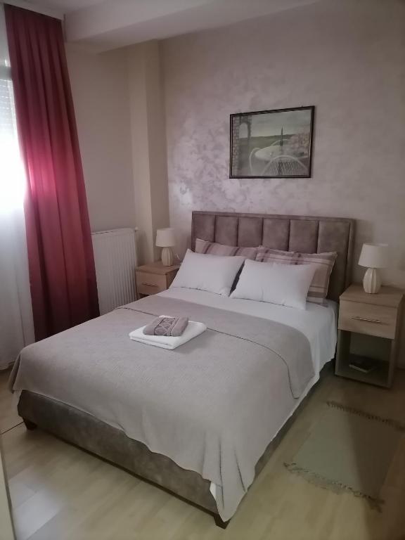 a bedroom with a large bed with a tray on it at Apartman Jabuka in Paraćin