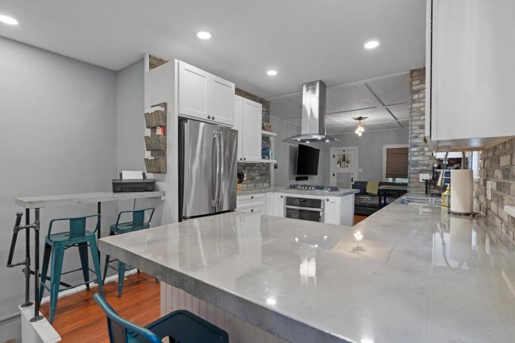 a large kitchen with a large counter and chairs in it at Plunge Pool Haven King bed in Loveland