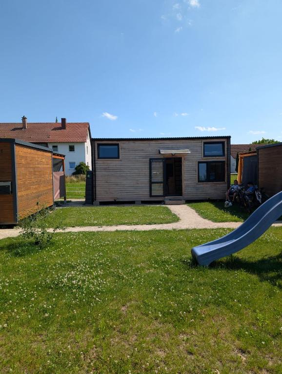 a playground with a slide in a yard at Tinyhouse auf der Fischer-Ranch in Westerheim