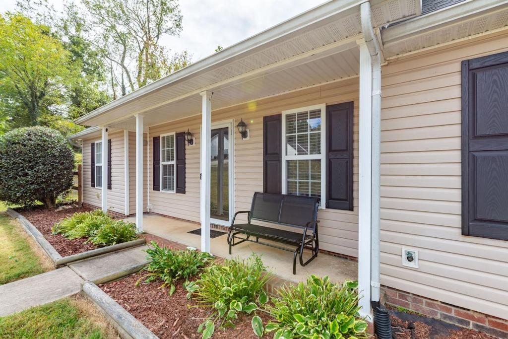 a porch of a house with a bench on it at Family & Couples Getaway Near Lake Norman Firepit King Suite in Troutman