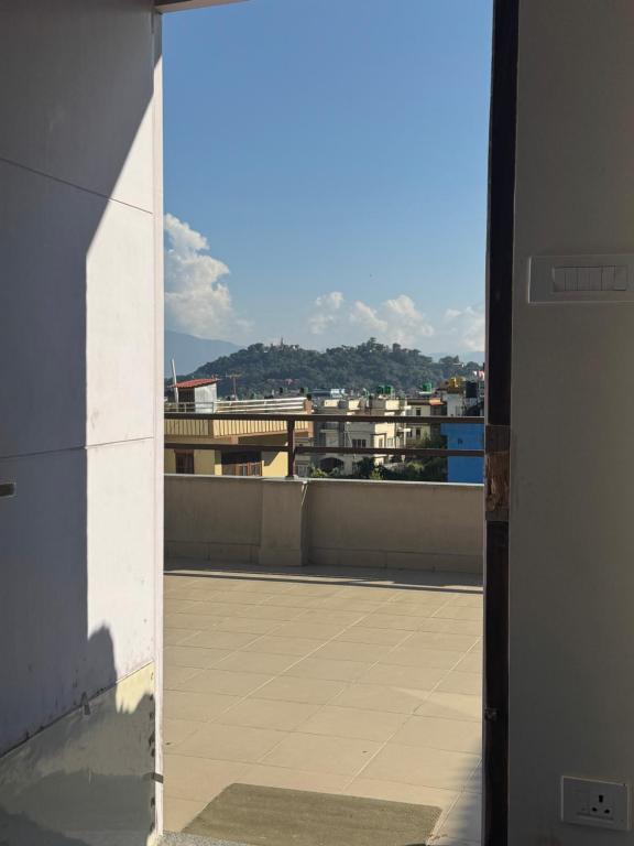 a view from an open door of a roof at My Stay Nepal in Kathmandu