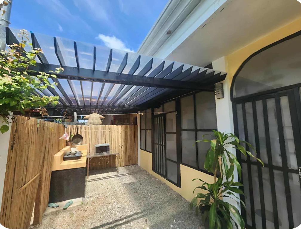 a pergola on the side of a house at JMC7 Furnished Villa Near Panglao Airport in Panglao