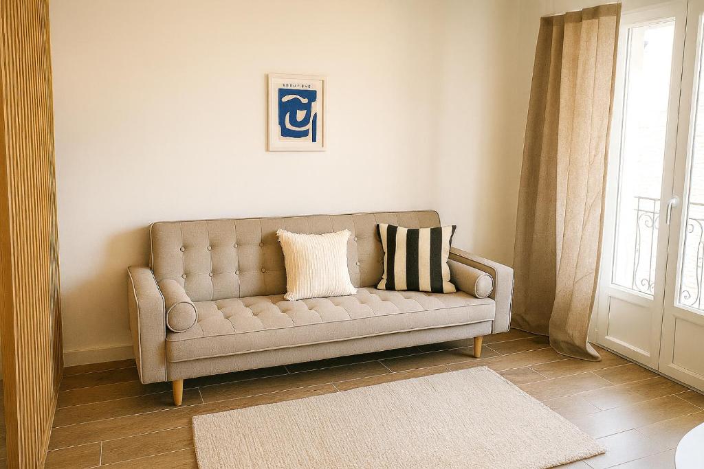 a couch in a living room with a window at Appartement de charme Digoin #18 in Digoin