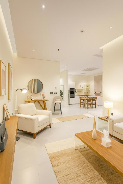 a living room with white furniture and a table at The Nest Loft in Riyadh
