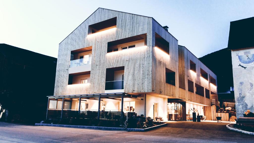 a large building with lights on the side of it at Gourmet - Boutique Hotel Tanzer in Falzes