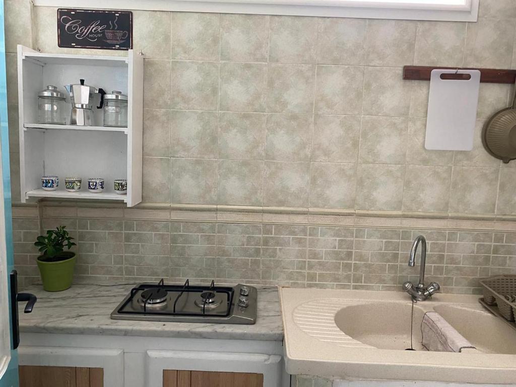 a kitchen with a stove and a sink at Dar Saïda Guest house in Tunis