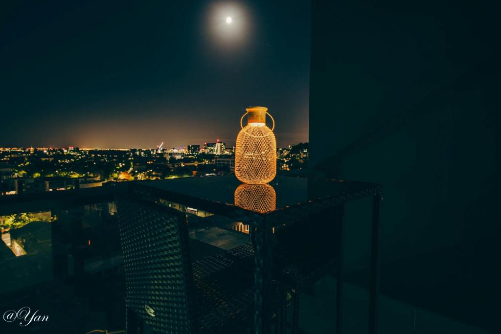 a bottle sitting on top of a building at night at Trainer's Cozy Home - Town of Beginnings マサラタウンのトレーナーのおうち in Melbourne