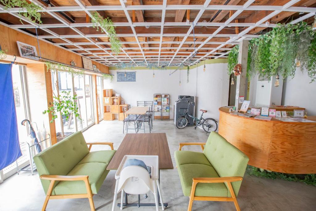 a room with chairs and a table and a bar at 一棟貸し切り宿 Hojo Machi Hostel in Kasai