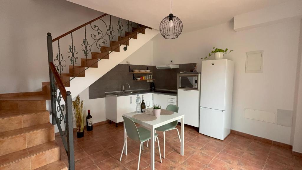 a kitchen with a table and a white refrigerator at Estudio las lajas in Chío