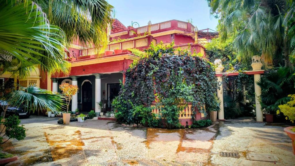 a building with a large plant in front of it at Ranjit's Svaasa Amritsar in Amritsar