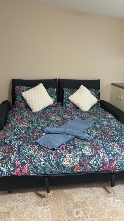 a bed with a blanket and two pillows on it at O'Briens Luxury Studio City Centre in Galway