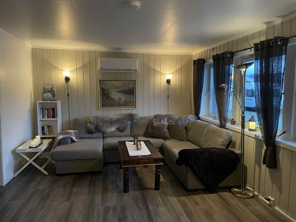 a living room with a couch and a table at Leilighet i Sør-Fron kommune in Sør-Fron