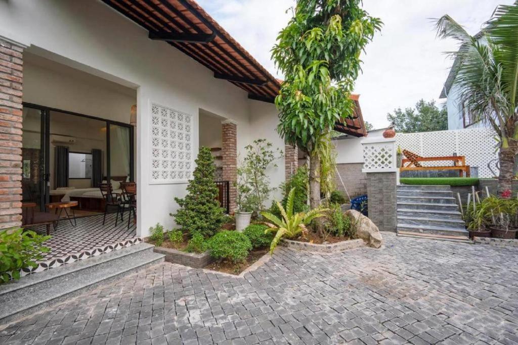 a house with a courtyard with a patio at Như House Apartment - Phú Quốc in Phú Quốc