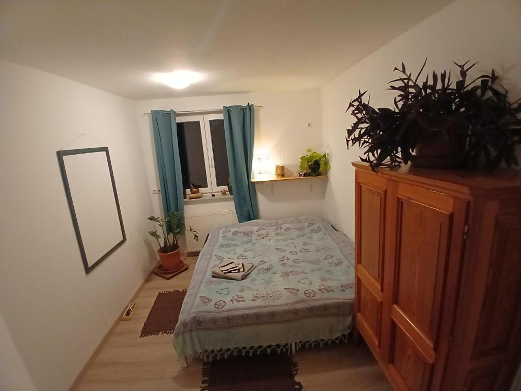 a bedroom with a bed and a dresser and a mirror at Zimmer im Salzkammergut in Bad Ischl