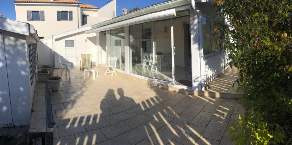 a shadow of a person taking a picture of a house at Chez Christine et Jean-Louis in Fouras