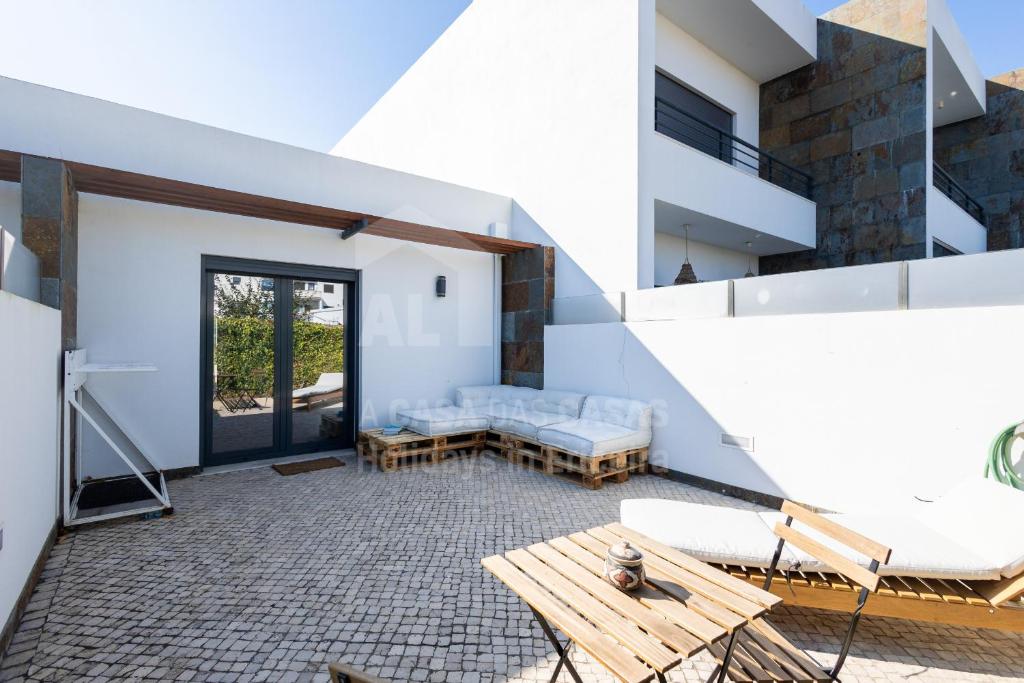 a living room with a couch and a table at Valentin House by ACasaDasCasas in Santo Isidoro