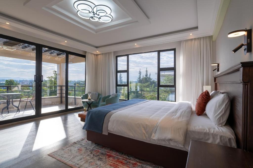 a bedroom with a bed and a large window at SuCasa Villa located in Maiyan Luxury Resort, Nanyuki in Nanyuki