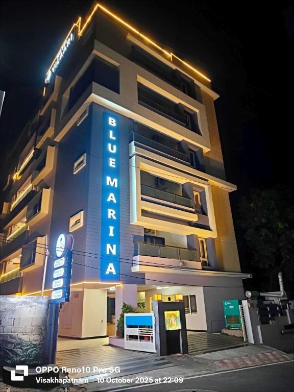 a building with a hotel sign in front of it at Hotel Vilaari Blue Marina in Visakhapatnam