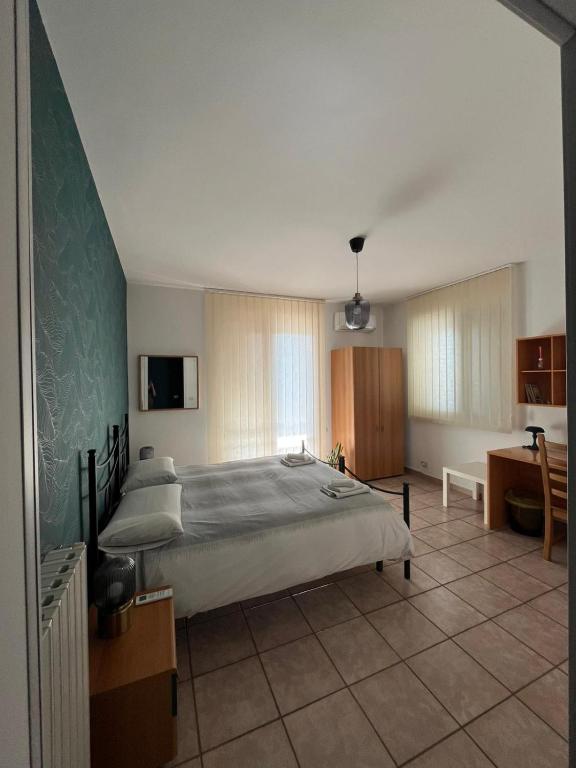 a bedroom with a large bed in a room at B&B Pokerdassi in Leonforte