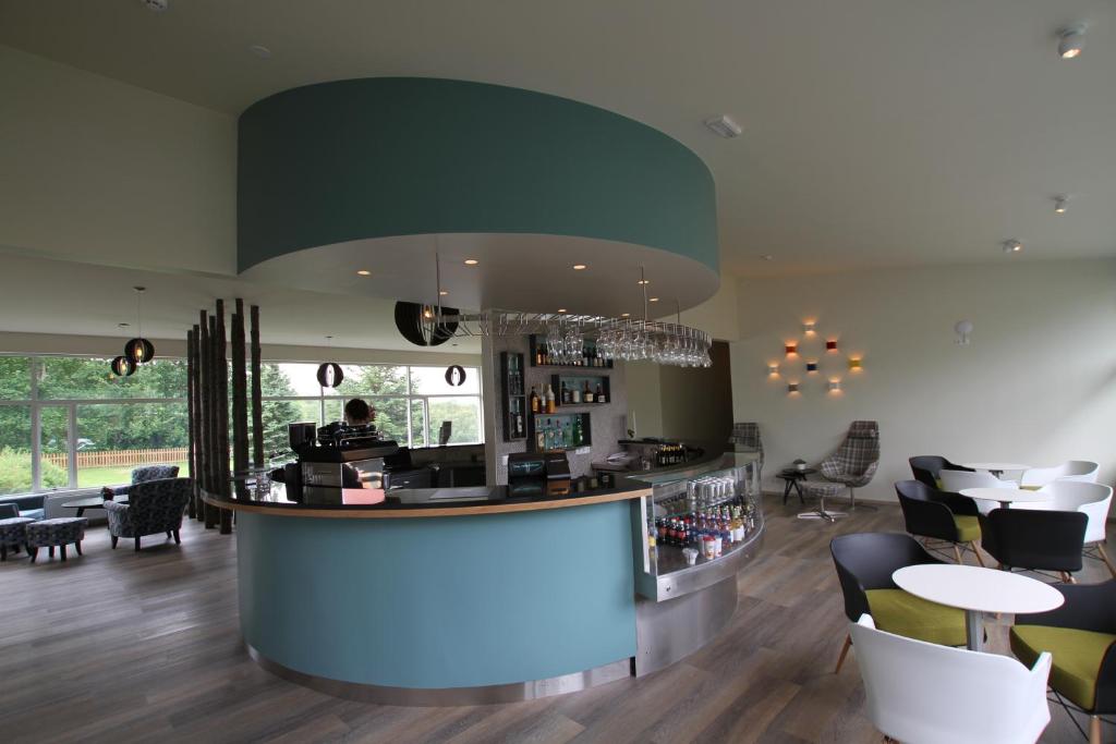 a bar in a restaurant with chairs and tables at Hotel Hallormsstadur in Hallormsstaður