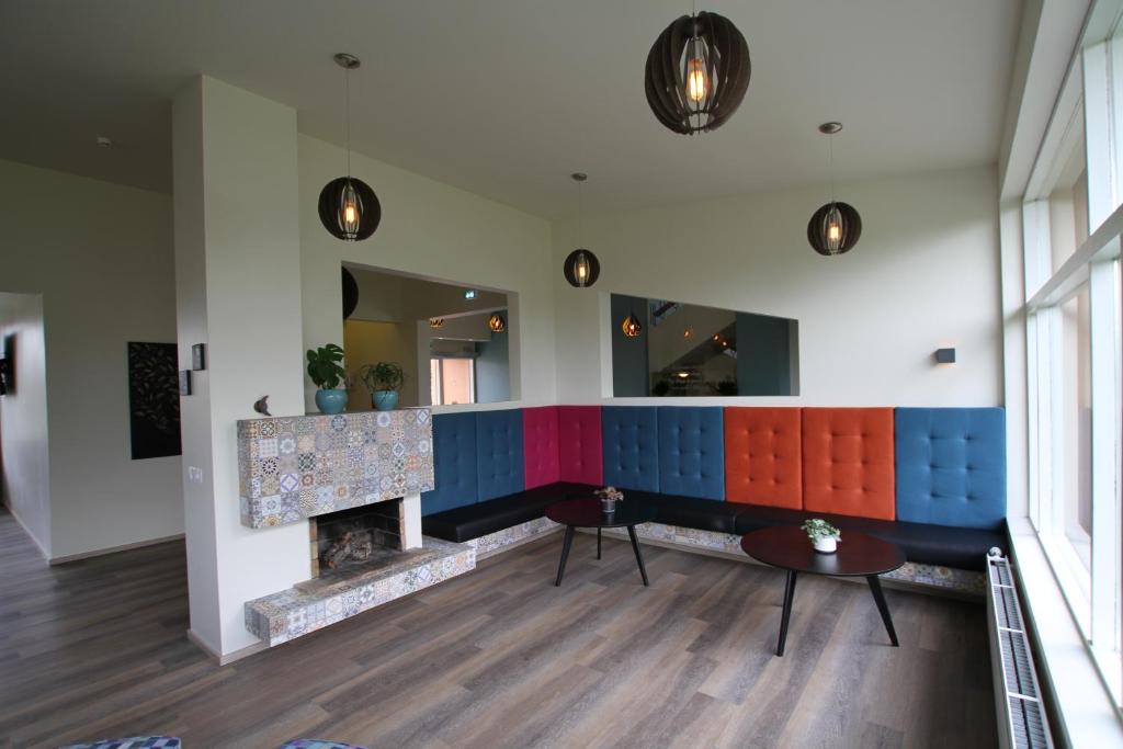 a room with a fireplace and colorful walls at Hotel Hallormsstadur in Hallormsstaður
