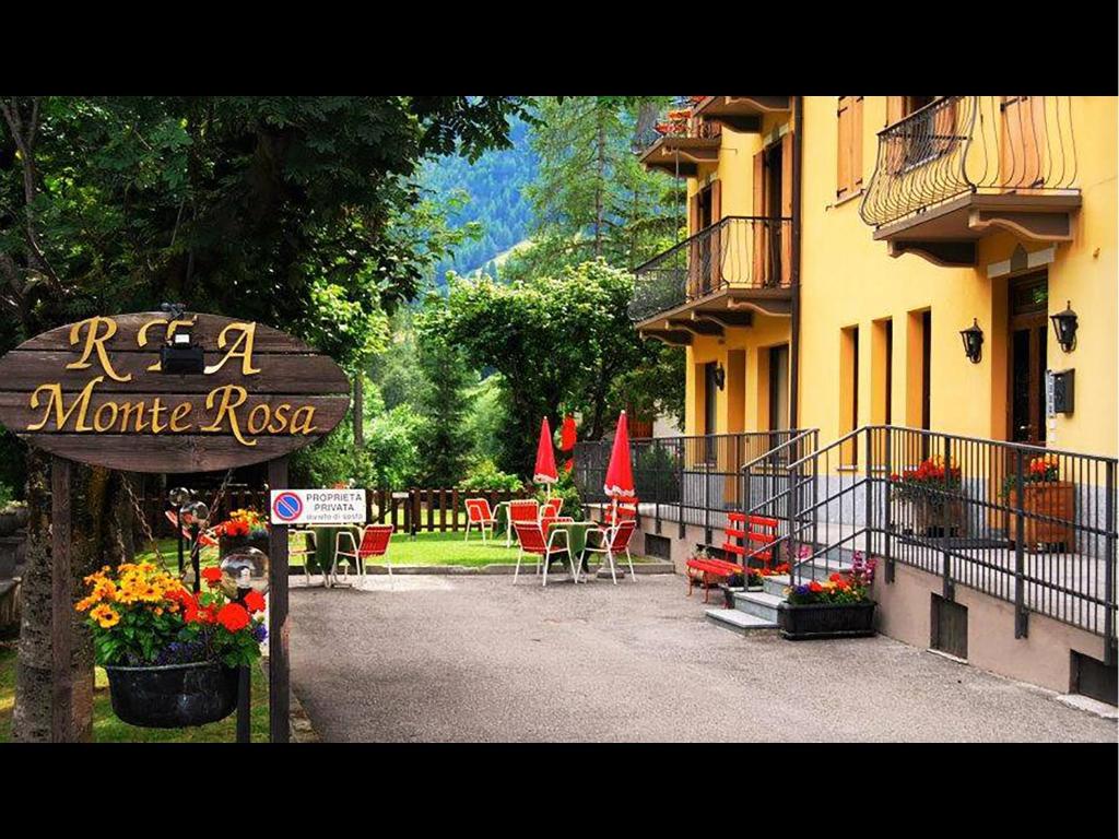 a sign in front of a building with a restaurant at R.T.A. Hotel Monte Rosa in Champoluc