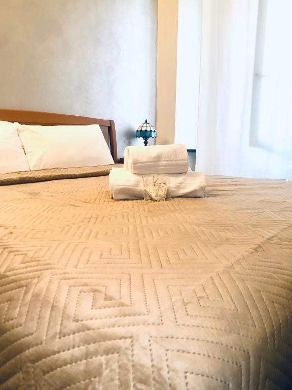 a large bed with two white pillows on it at Mediterranium in Loano