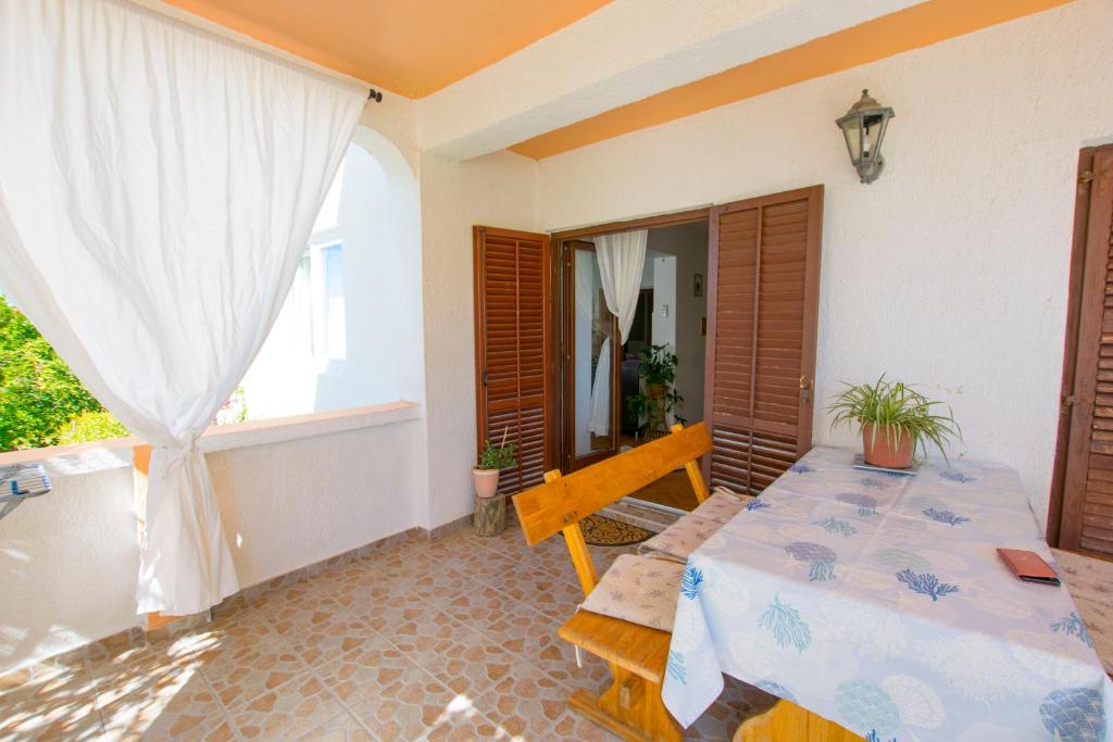 a room with a table and a window at Apartments Rasic in Palit