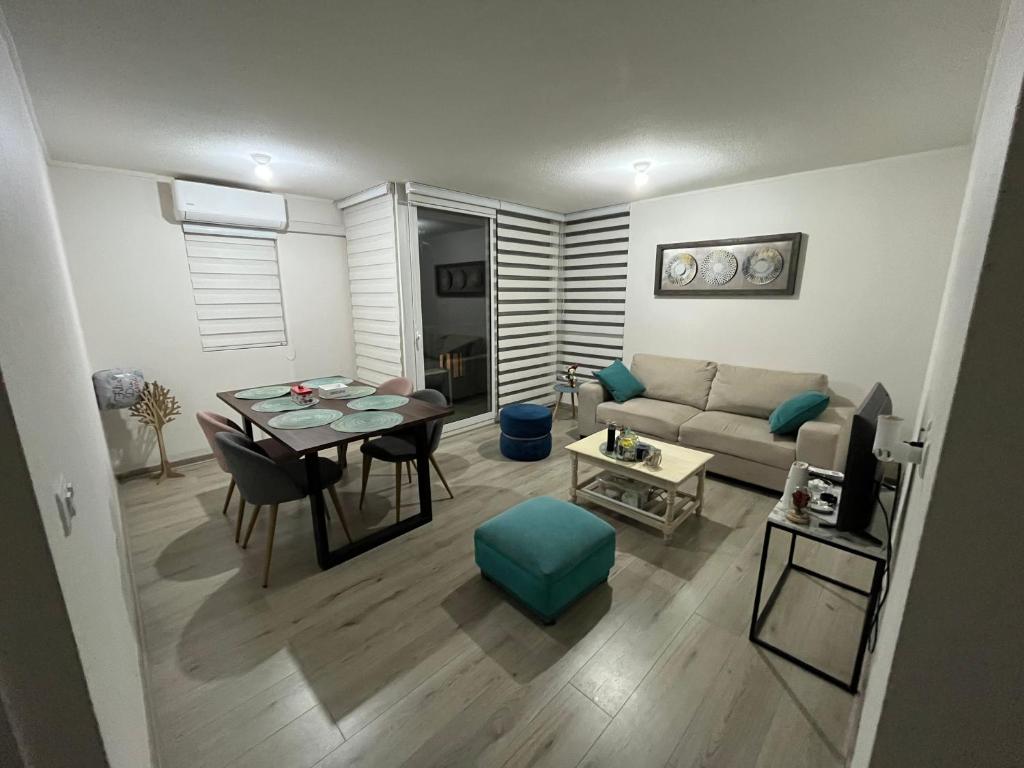 a living room with a table and a couch at Departamento Temuco in Temuco