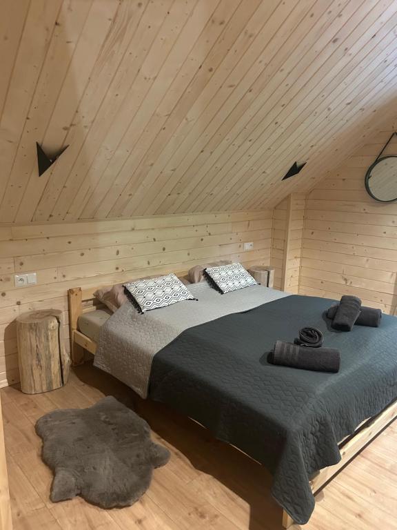 a bedroom with a large bed in a wooden room at Jodełkowa Stodoła in Tylmanowa