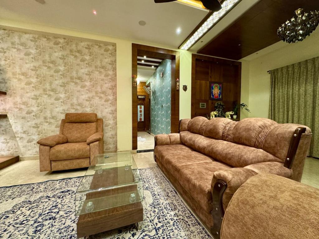 a living room with a couch and a chair at Ultra Luxurious 4 BHK VILLA in Bengaluru