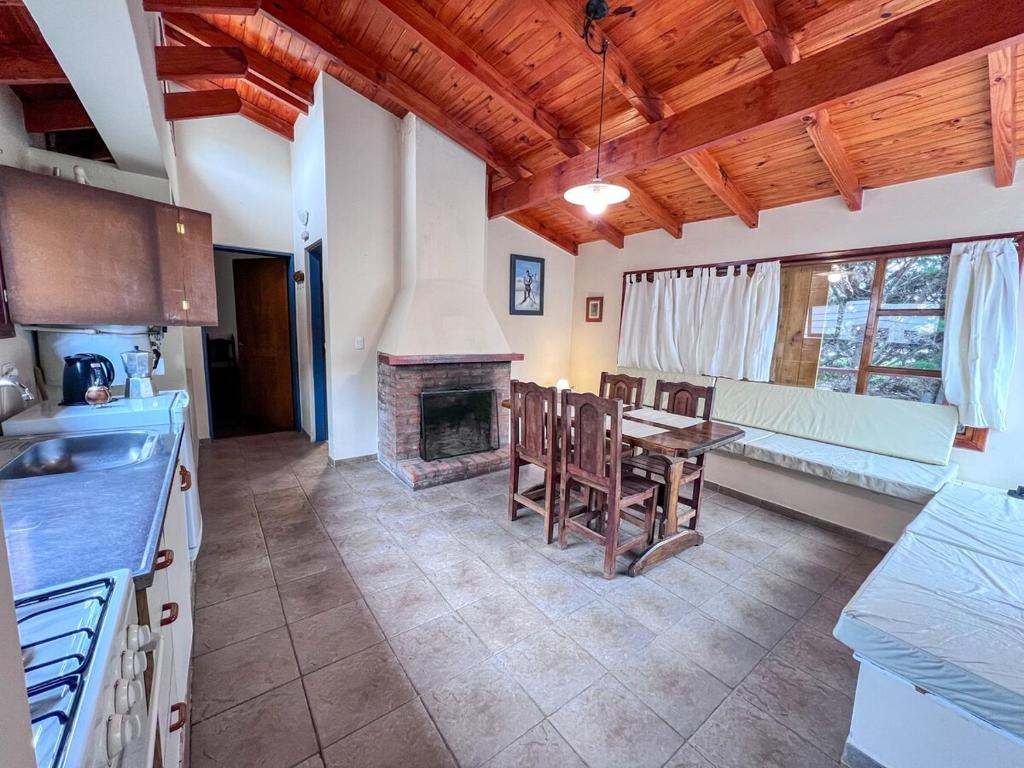 a kitchen with a table and a fireplace at Casa Pier Giorgio Bella Vista in El Chalten