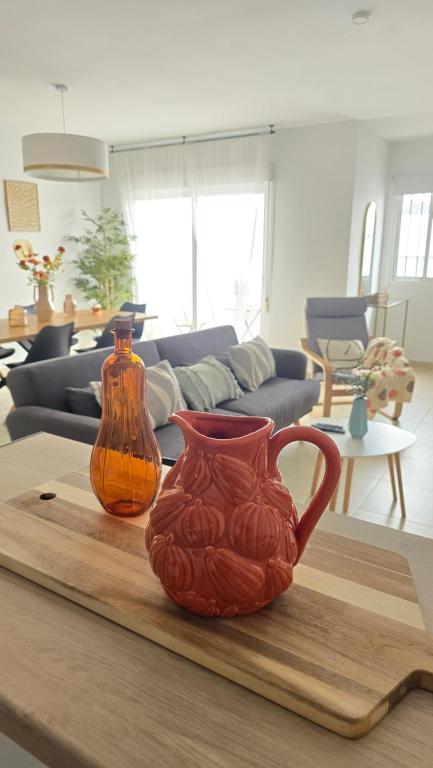 two vases sitting on a table in a living room at Casa Serena Alojamiento Rural in Enix