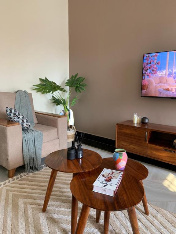 a living room with a coffee table and a tv at True's cozy homes in Kira
